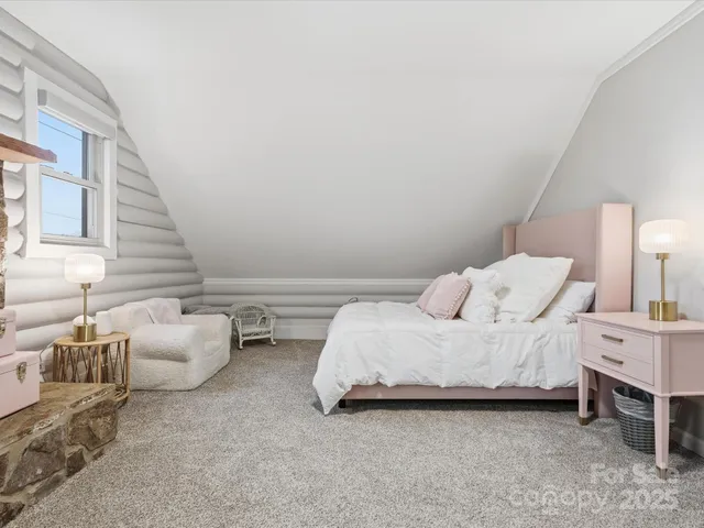 a bedroom with bed and a couch