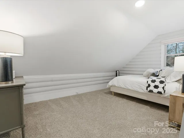 a spacious bedroom with a bed and a couch