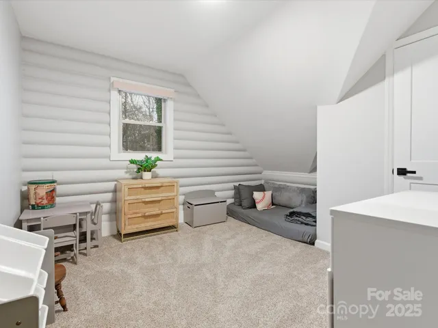 a room with furniture and a potted plant