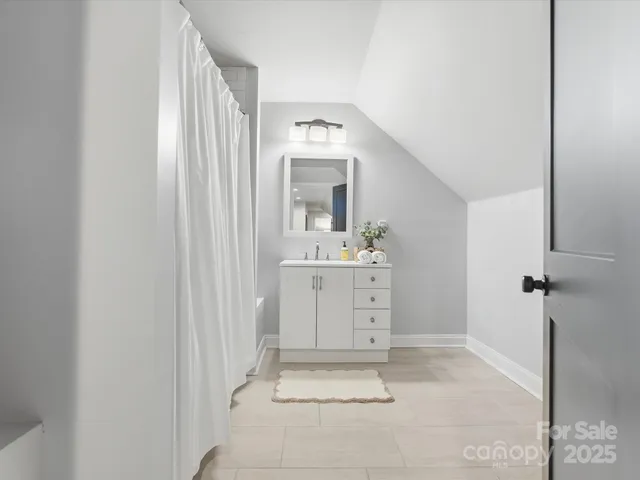 a bathroom with a sink vanity and mirror