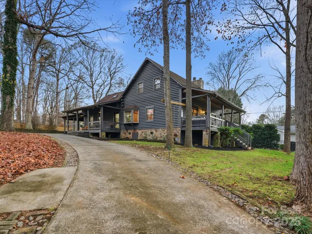 an aerial view of a house with a yard and lake view