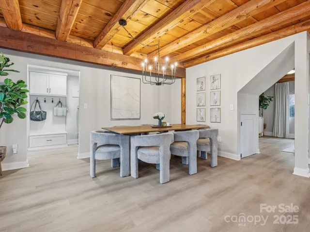 a view of a dining room with furniture and chandelier