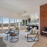 a living room with furniture and a floor to ceiling window