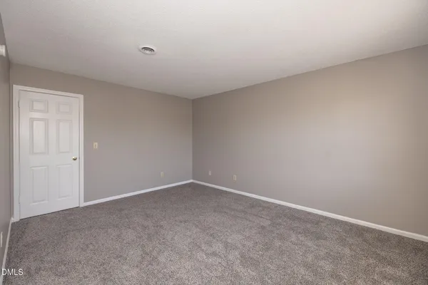 a view of an empty room and entryway