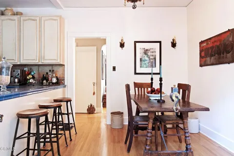 a view of a dining room with furniture and wooden floor