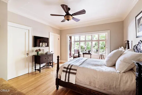 a bedroom with a bed and a large window
