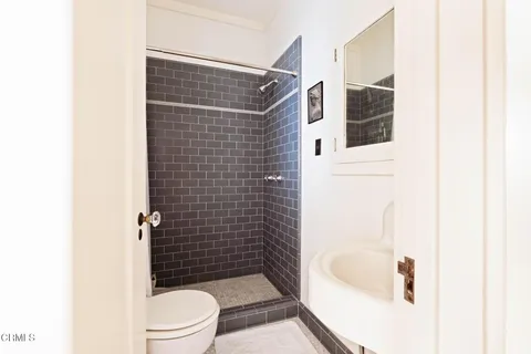 a bathroom with a shower toilet and sink
