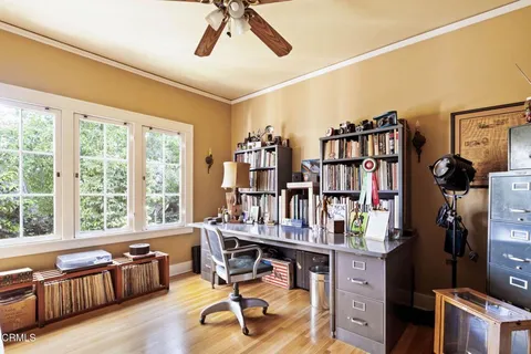 a view of a workspace with furniture and a window
