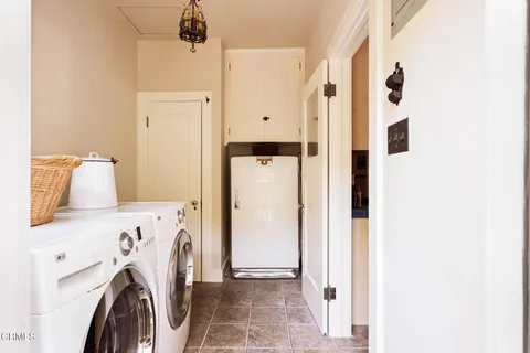 a view of a storage & utility room with a washer dryer