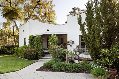 a front view of a house with garden