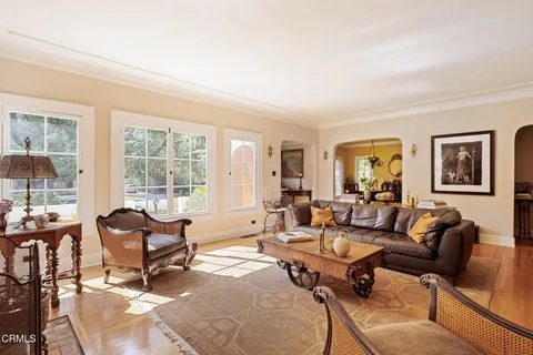 a living room with furniture and a floor to ceiling window