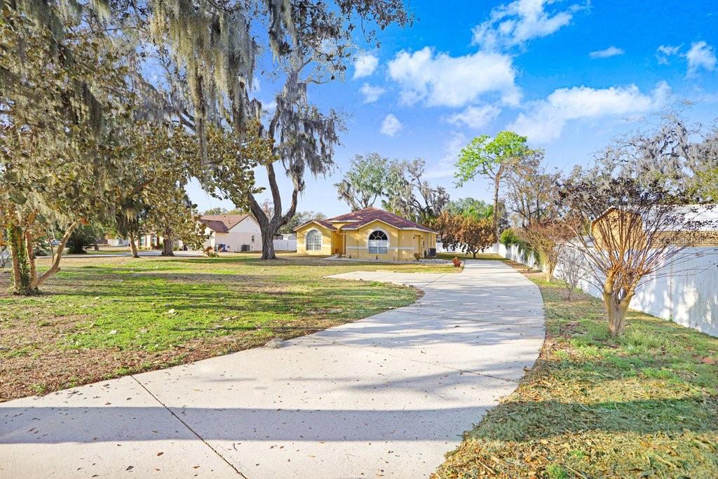 2412 Durant Road Valrico, FL 33594 - Photo 25 of 26 a view of a yard with yellow lighting