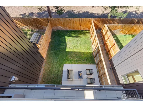 a view of a backyard with wooden fence