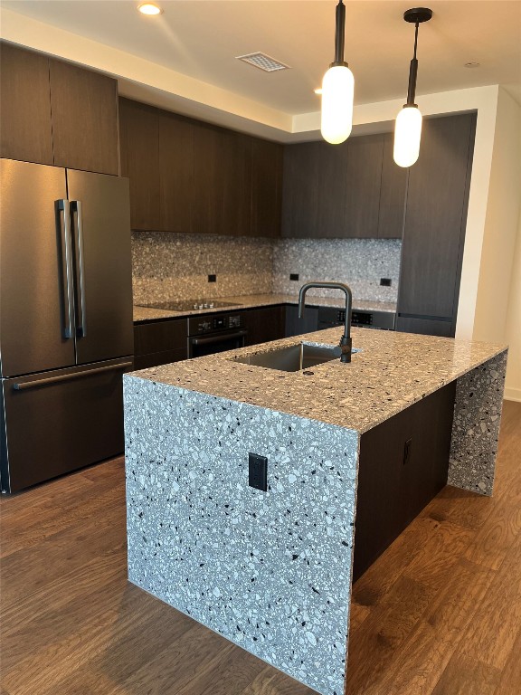 84 East Avenue, Unit 1502 Austin, TX 78701 - Photo 2 of 11 a kitchen with kitchen island a counter top space a sink and refrigerator