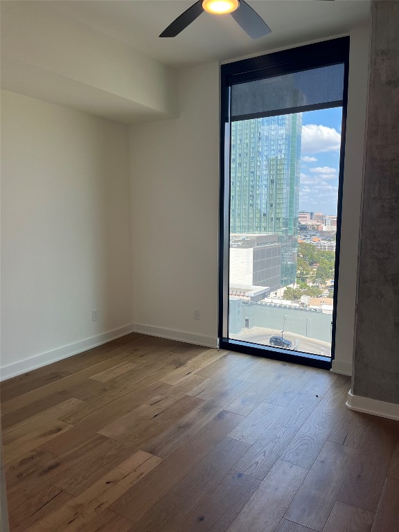 84 East Avenue, Unit 1502 Austin, TX 78701 - Photo 4 of 11 a view of an empty room with wooden floor and a window