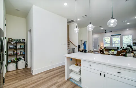 a view of a kitchen and dining room with wooden floor