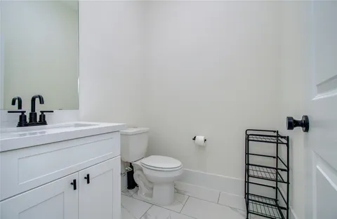 a bathroom with a toilet a sink and view