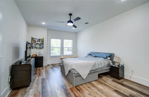 a bedroom with a bed and wooden floor