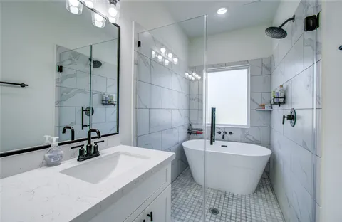 a bathroom with a sink and a large mirror