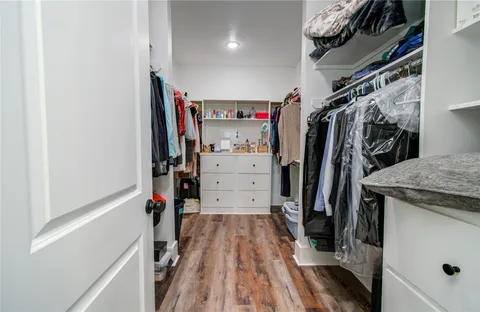 a view of walk in closet with clothes
