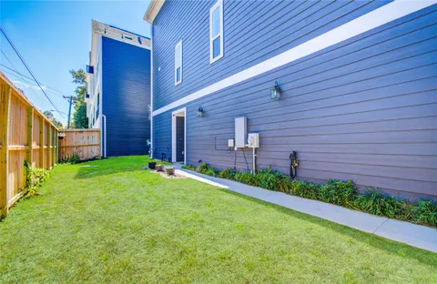 a view of a backyard with potted plants and wooden fence