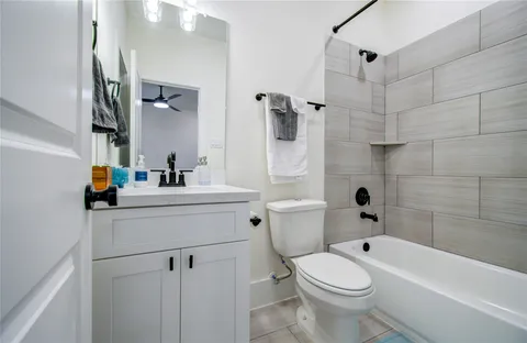 a bathroom with a sink toilet vanity and shower