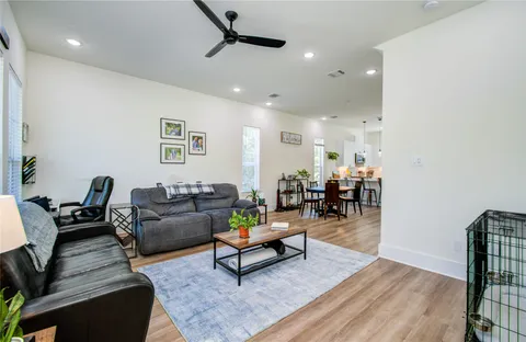 a living room with furniture and wooden floor