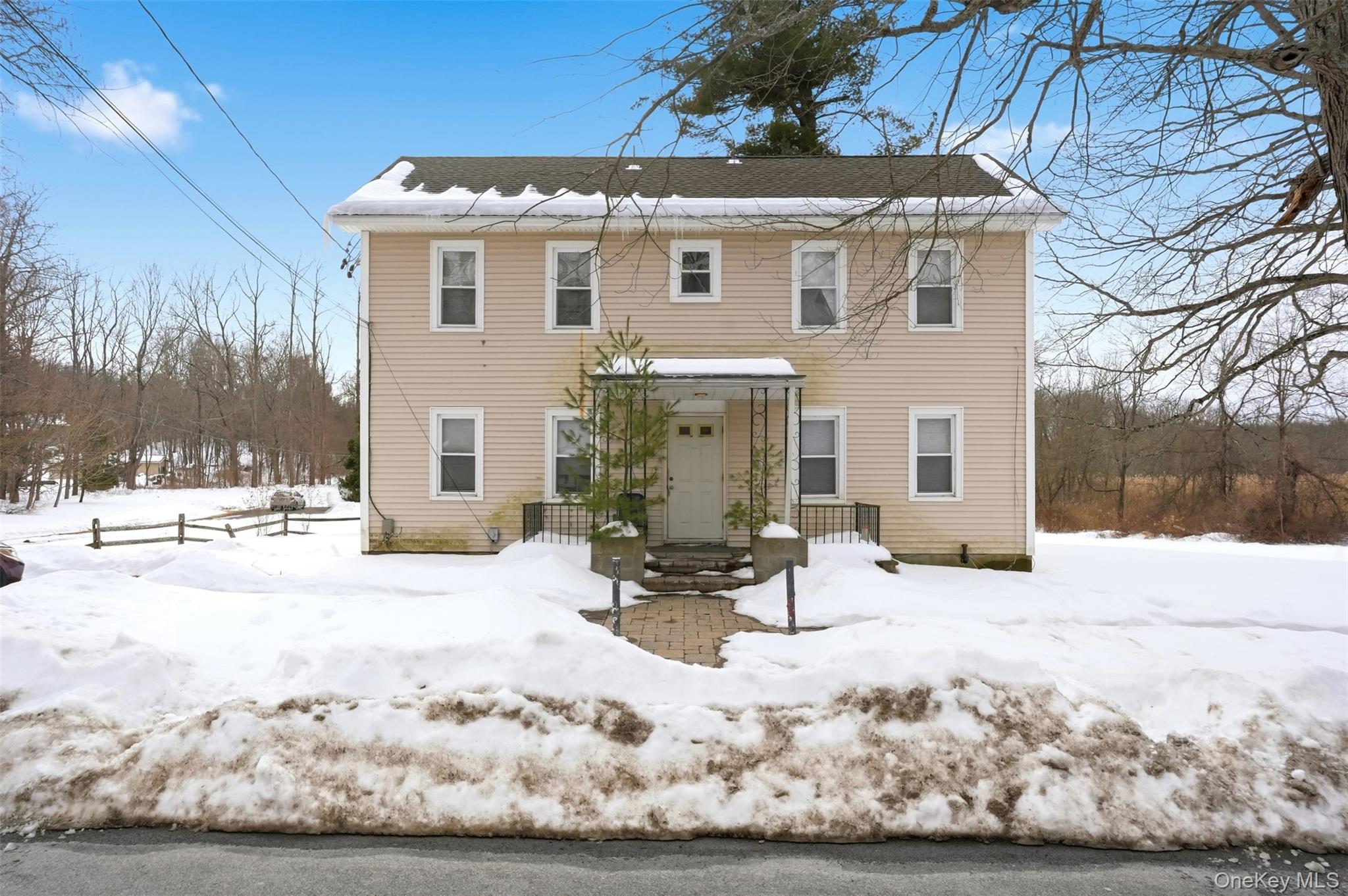 a view of a house with snow in the yard