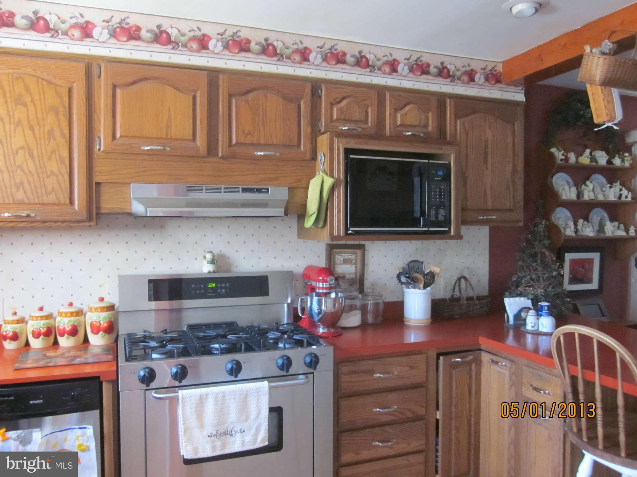 7617 Spruce Road Baltimore, MD 21222 - Photo 2 of 20 a kitchen with stainless steel appliances granite countertop a stove and cabinets