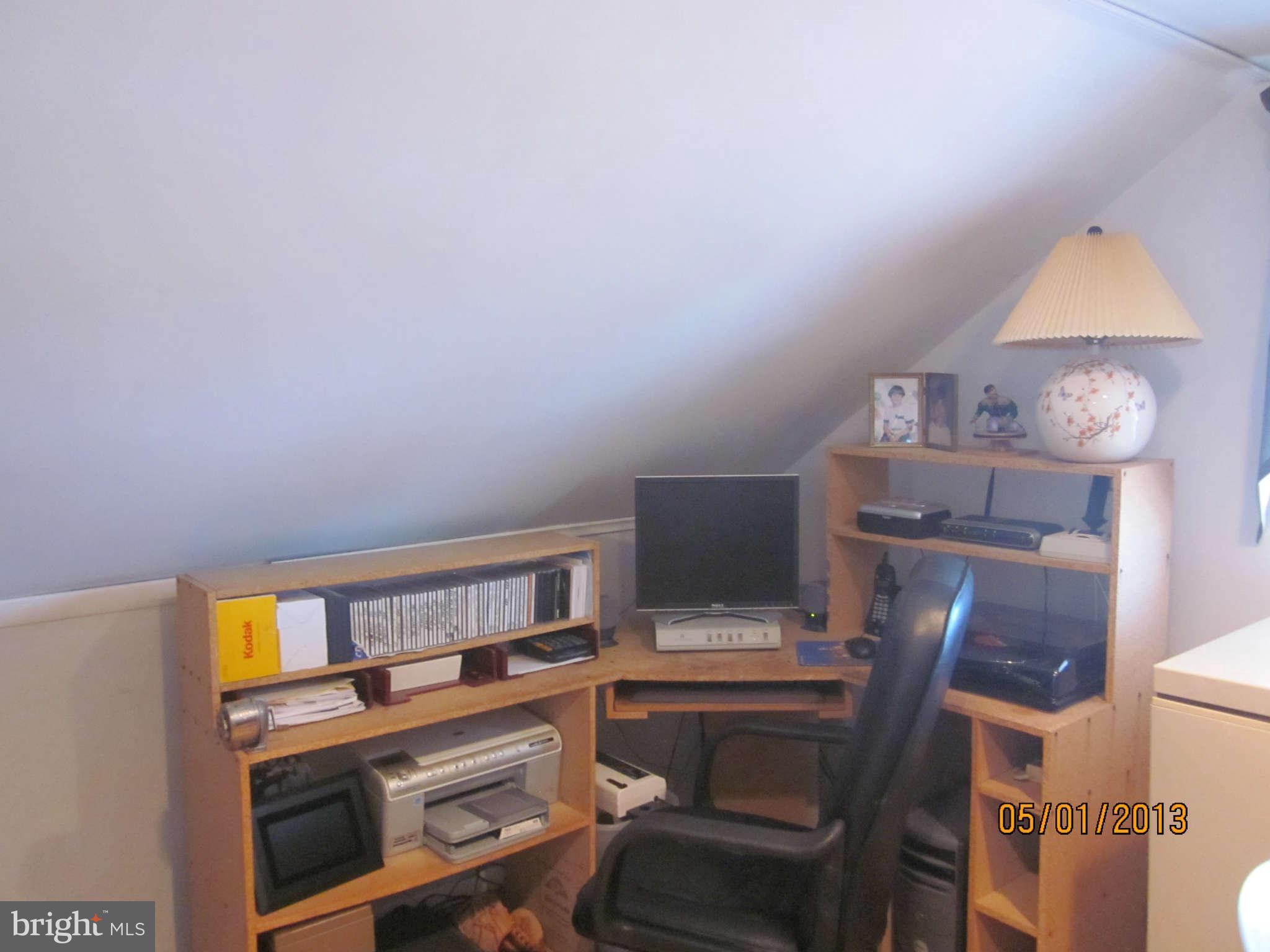 7617 Spruce Road Baltimore, MD 21222 - Photo 11 of 20 a view of a workspace with furniture and a lamp