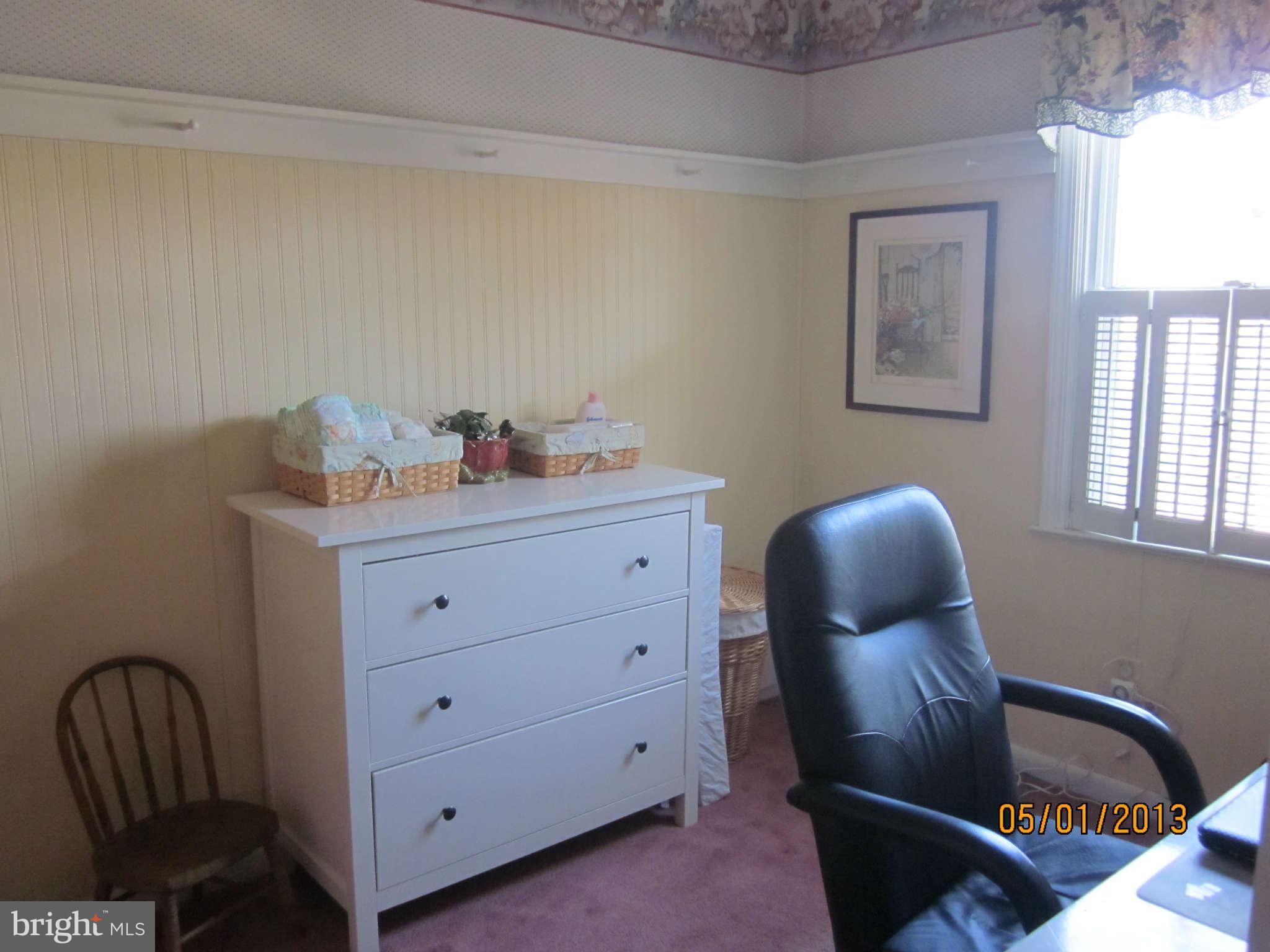 7617 Spruce Road Baltimore, MD 21222 - Photo 12 of 20 a room with a chair and a window