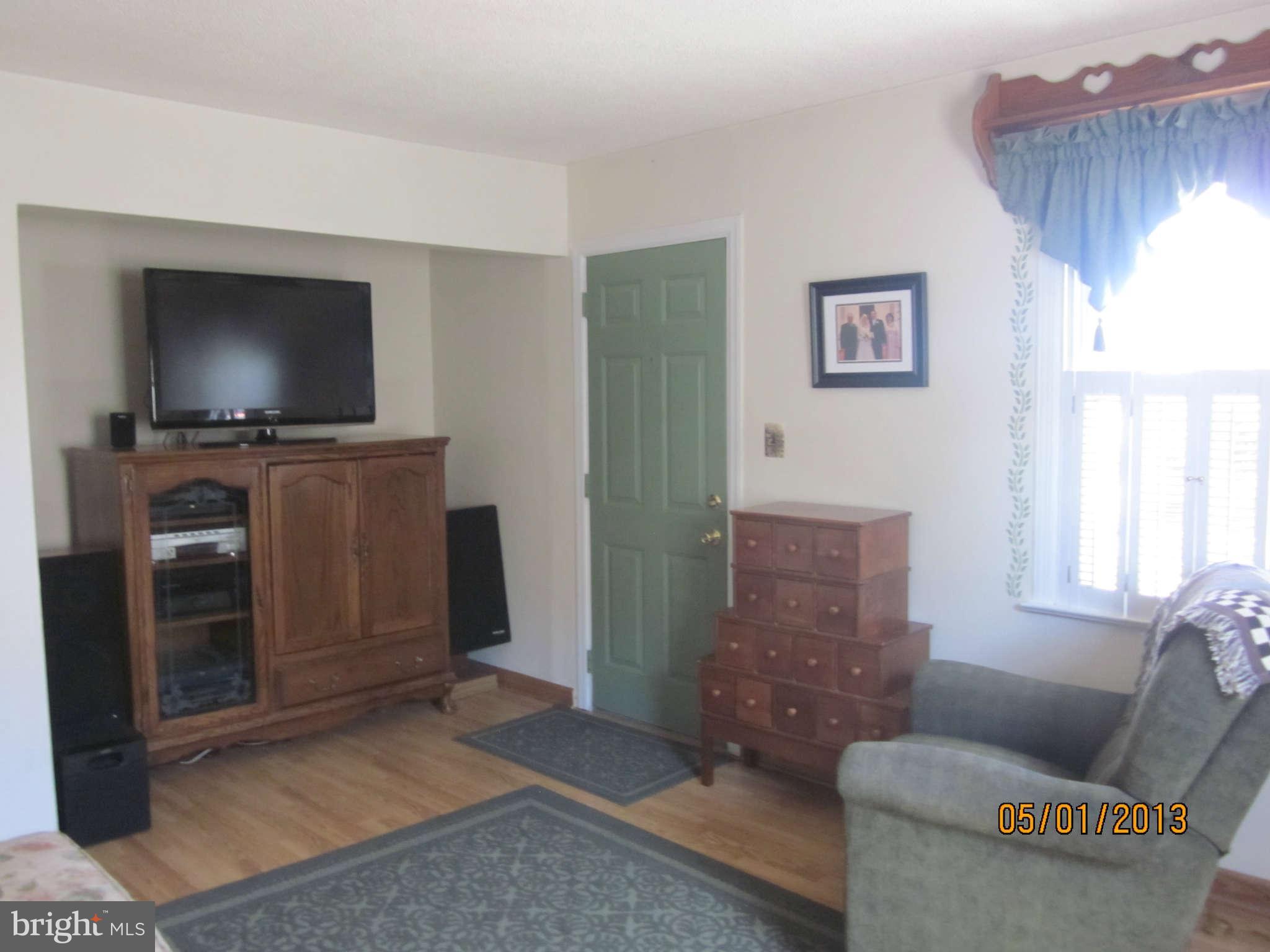 7617 Spruce Road Baltimore, MD 21222 - Photo 5 of 20 a living room with furniture and a flat screen tv