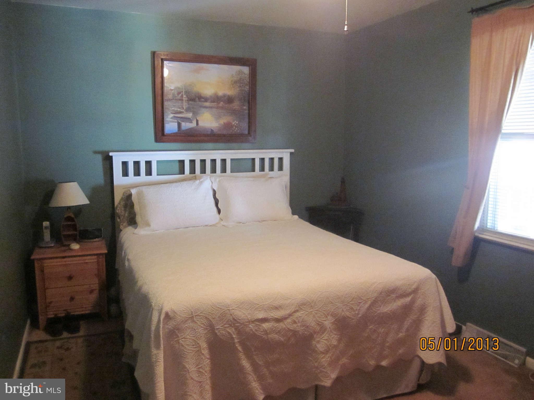 7617 Spruce Road Baltimore, MD 21222 - Photo 8 of 20 a bedroom with a bed and a window