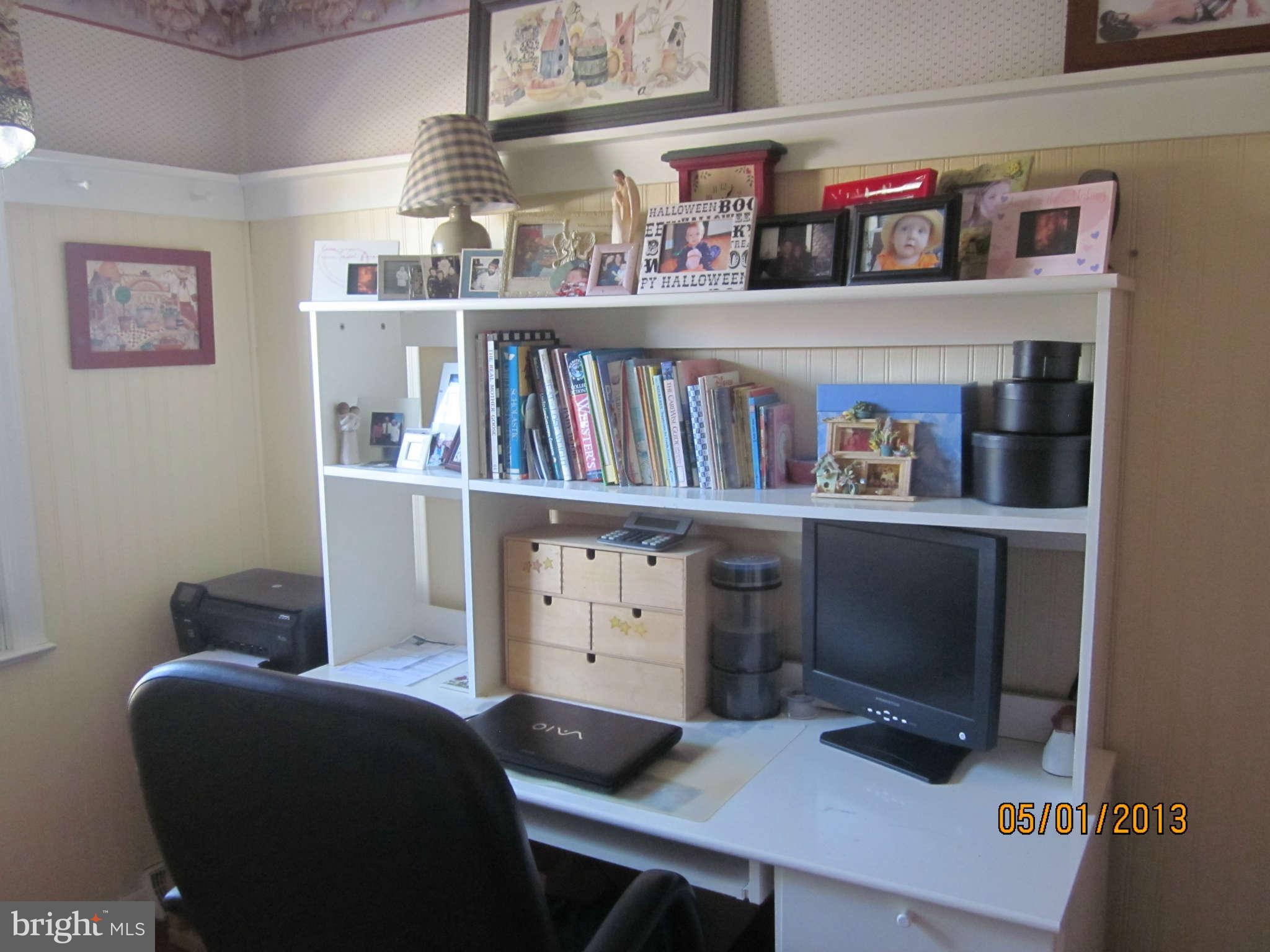 7617 Spruce Road Baltimore, MD 21222 - Photo 10 of 20 a room that has a bookshelf and a book shelf