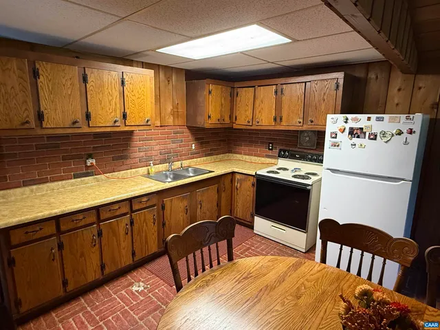 a view of a storage & utility room with a fridge