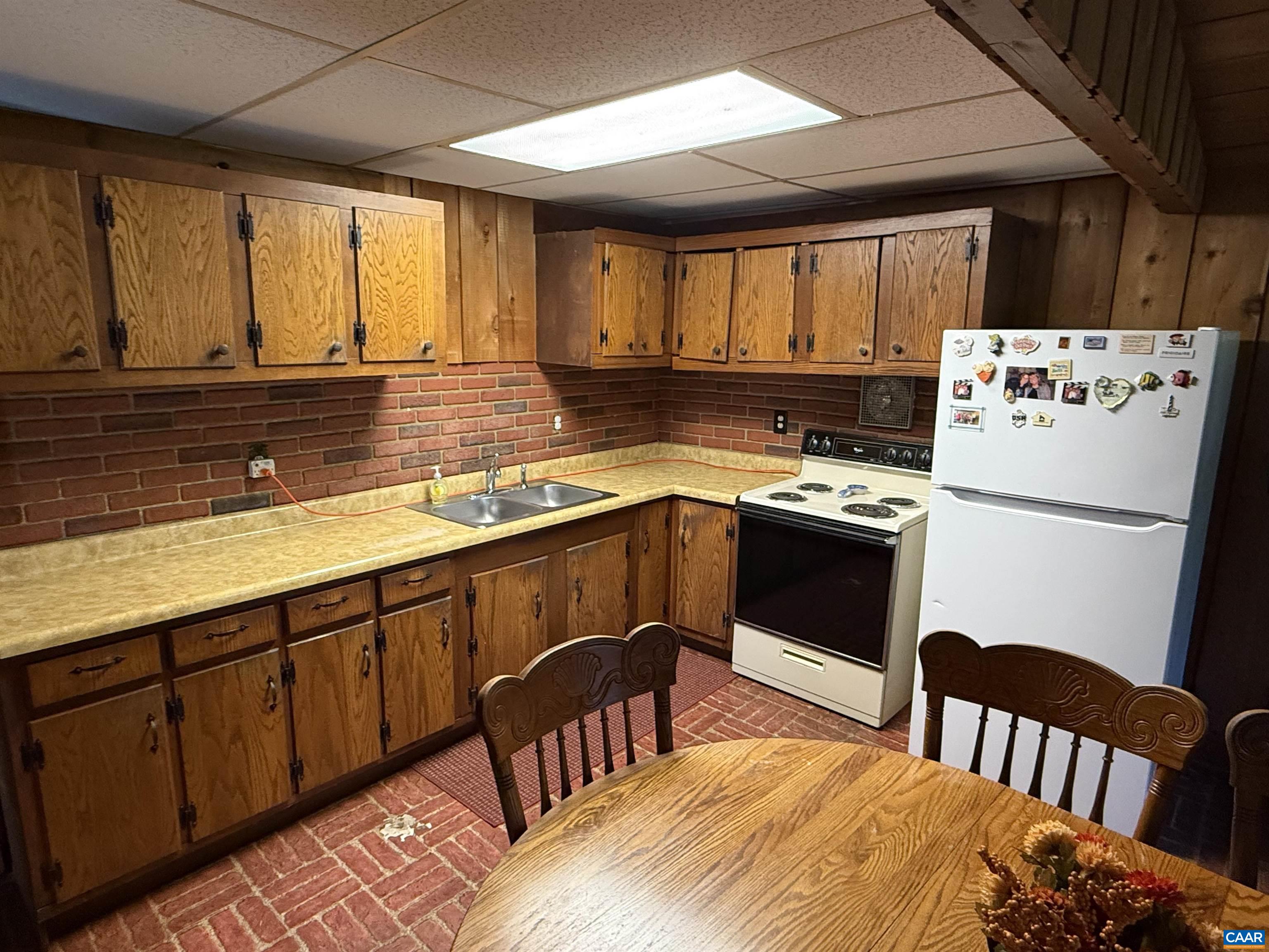 5609 New Line Road Gum Spring, VA 23065 - Photo 14 of 61 a kitchen with stainless steel appliances granite countertop a stove a sink dishwasher a refrigerator a dining table and chairs with wooden floor