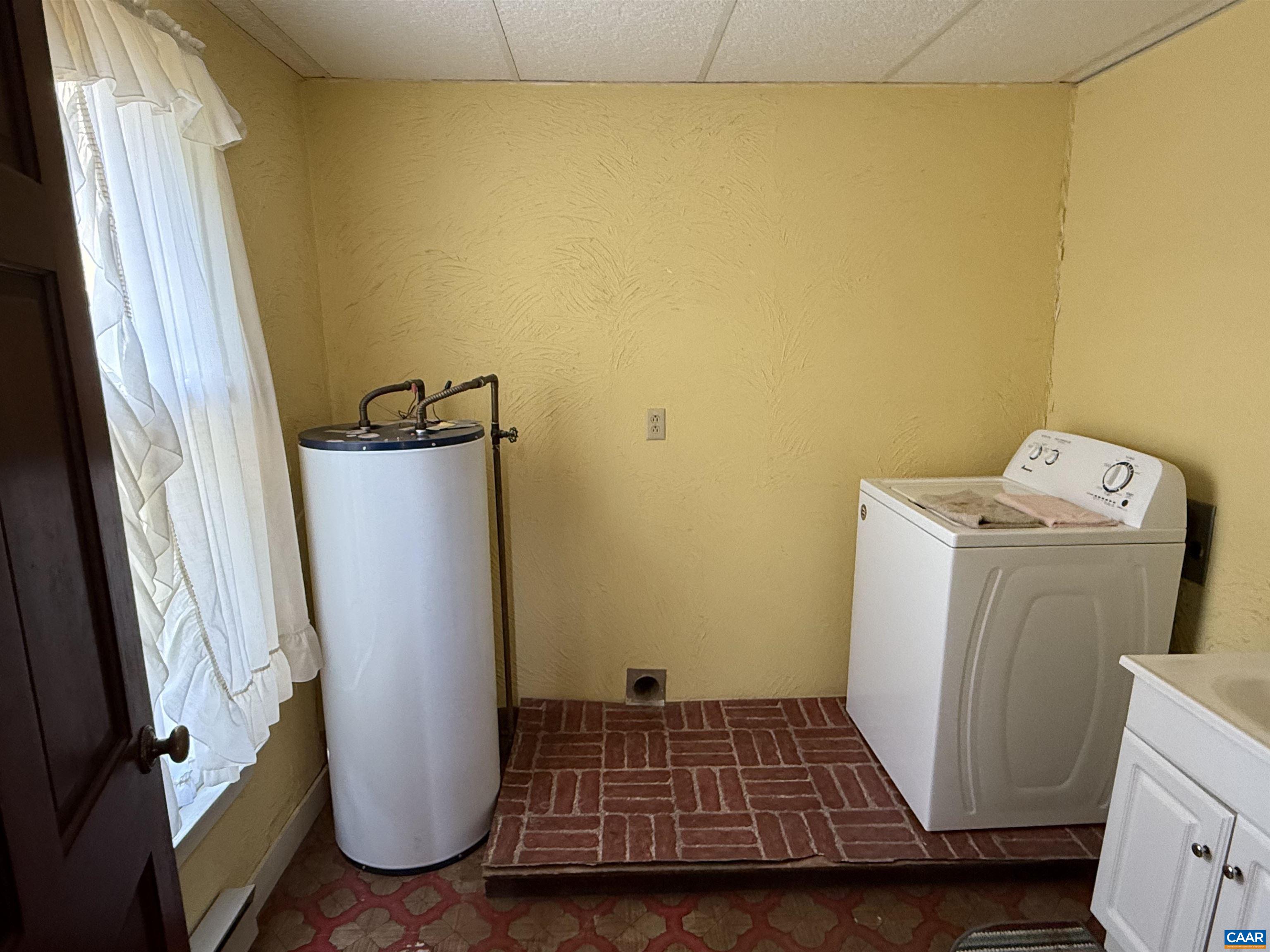 5609 New Line Road Gum Spring, VA 23065 - Photo 16 of 61 a view of a storage & utility room with a fridge