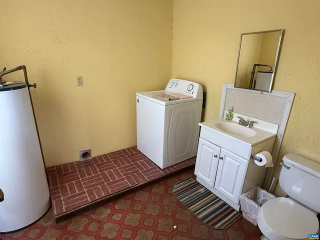 a bedroom with a bed and a flat tv screen on the dresser