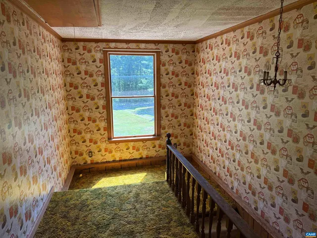 a bed sitting in a spacious bedroom next to a window