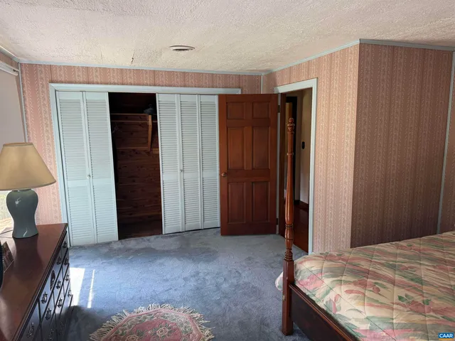 a view of empty room with wooden floor and furniture