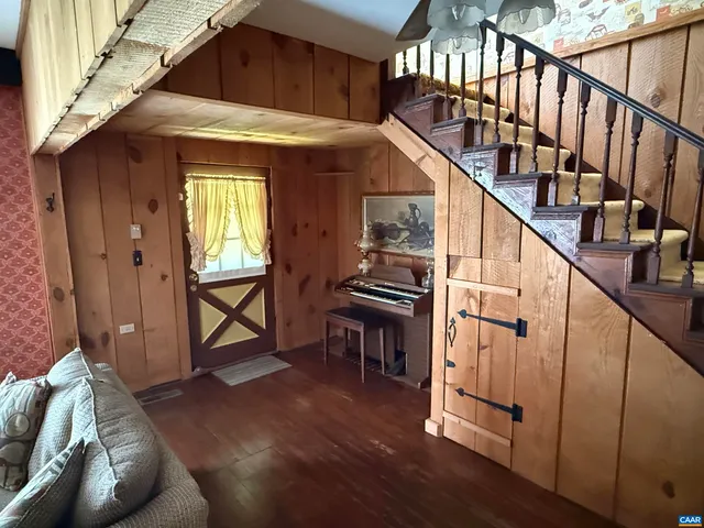 a view of entryway livingroom and hall with wooden floor