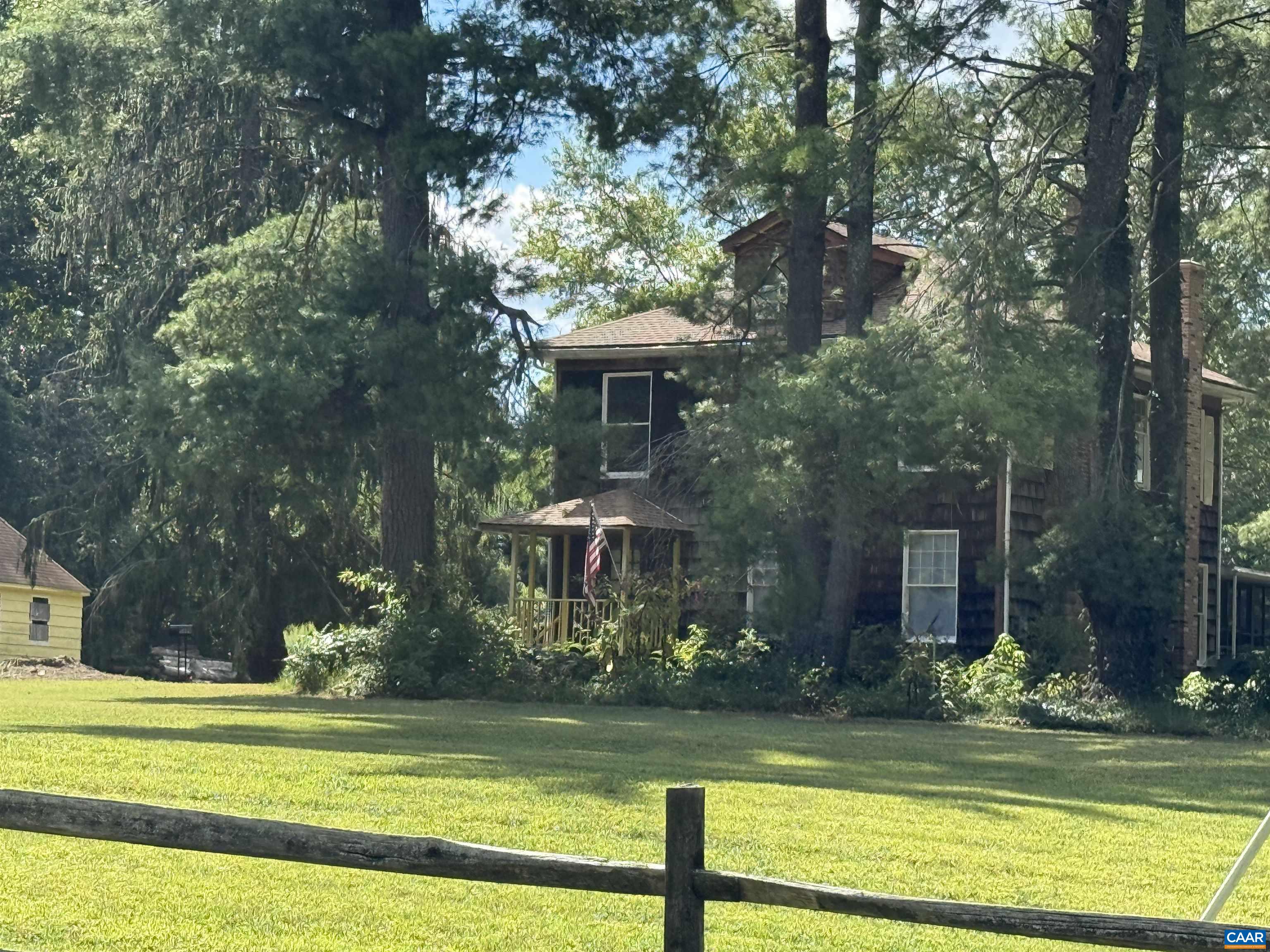5609 New Line Road Gum Spring, VA 23065 - Photo 52 of 61 a view of a house with a yard table and chairs