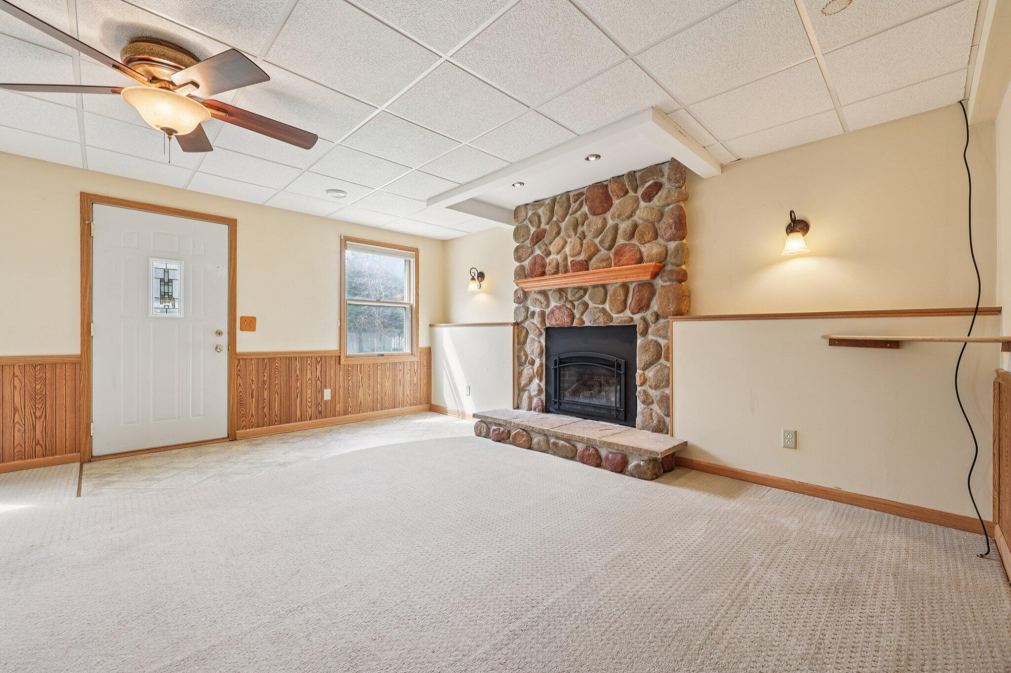 304 Aspen Court Delavan, WI 53115 - Photo 4 of 35 Lower Level Family Room with Fireplace