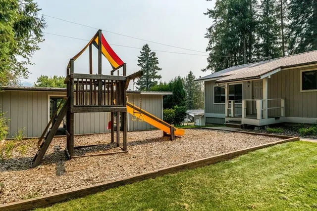 a view of a house with a wooden deck and a chair