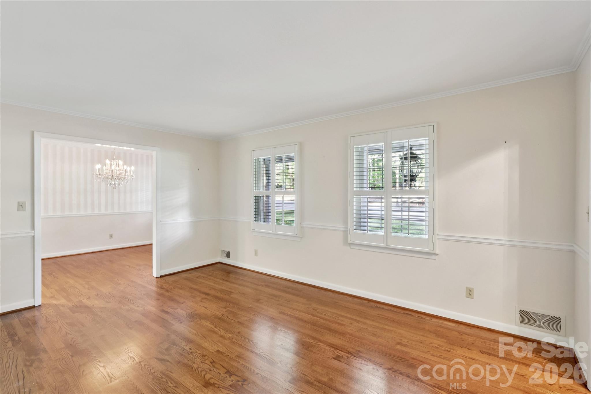 1002 Ridge Street Albemarle, NC 28001 - Photo 6 of 45 an empty room with wooden floor and windows