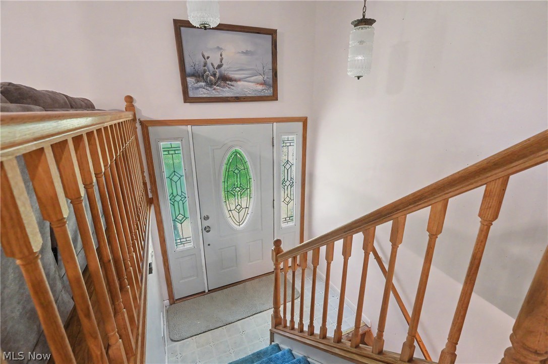 4250 Herr Fieldhouse Road Southington, OH 44470 - Photo 4 of 50 Entryway featuring a white door with decorative glass inserts, flanked by matching sidelights