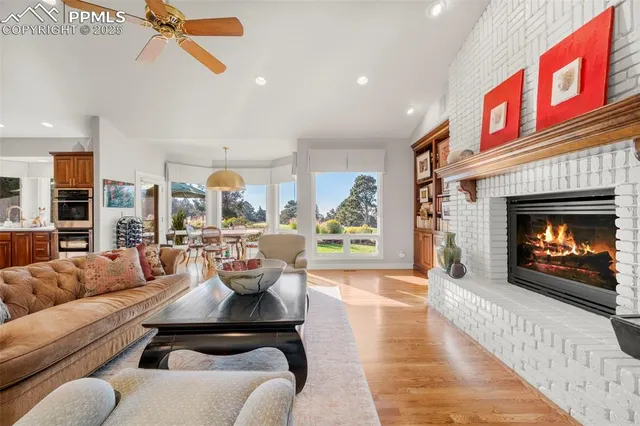 a living room with furniture kitchen view and a flat screen tv