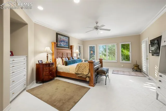 a large white kitchen with a large window and furniture