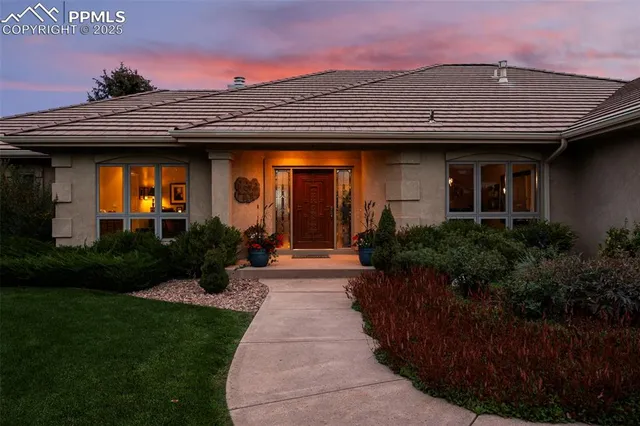 a front view of a house with garden