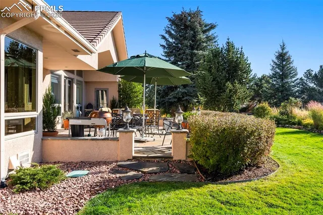 an aerial view of a house with garden space and mountain view